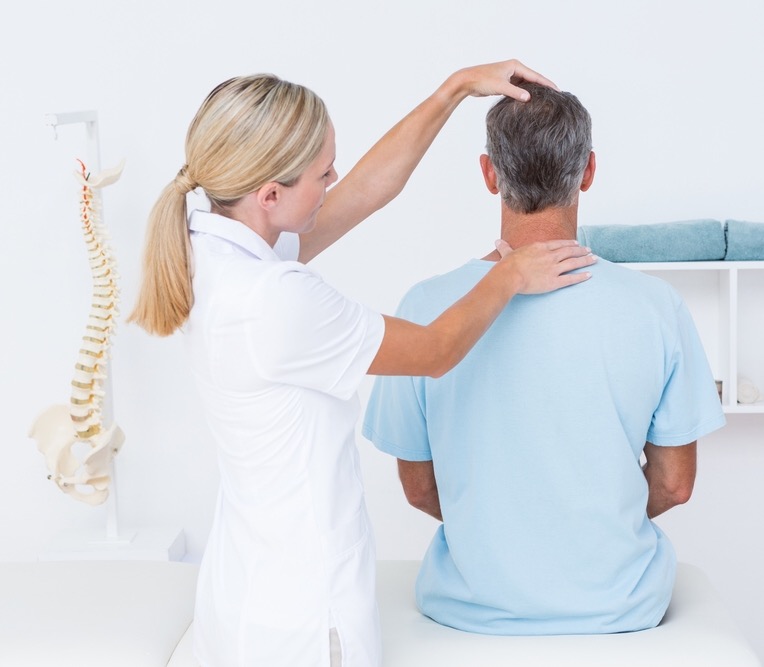 Osteopath assessing posture